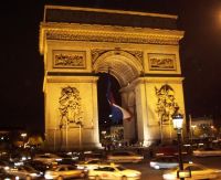 Traffic around Arc De Triomphe at night